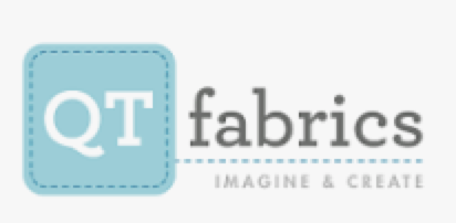 A logo for t fabrics, with the word 