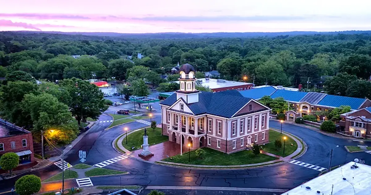 A church with a clock tower in the center of it.